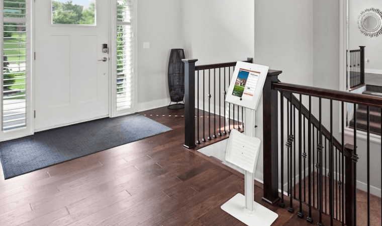 The entryway of a home with a laptop set up to process open house attendees